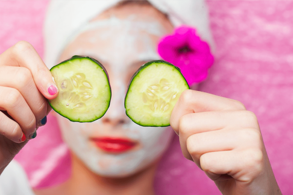 Woman holding cucumber slices on a spa day.